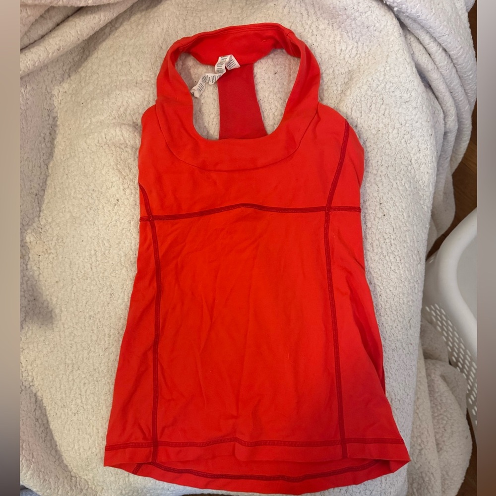 Size 4 Lululemon racerback yoga tank in excellent condition. Shelf bra in lining